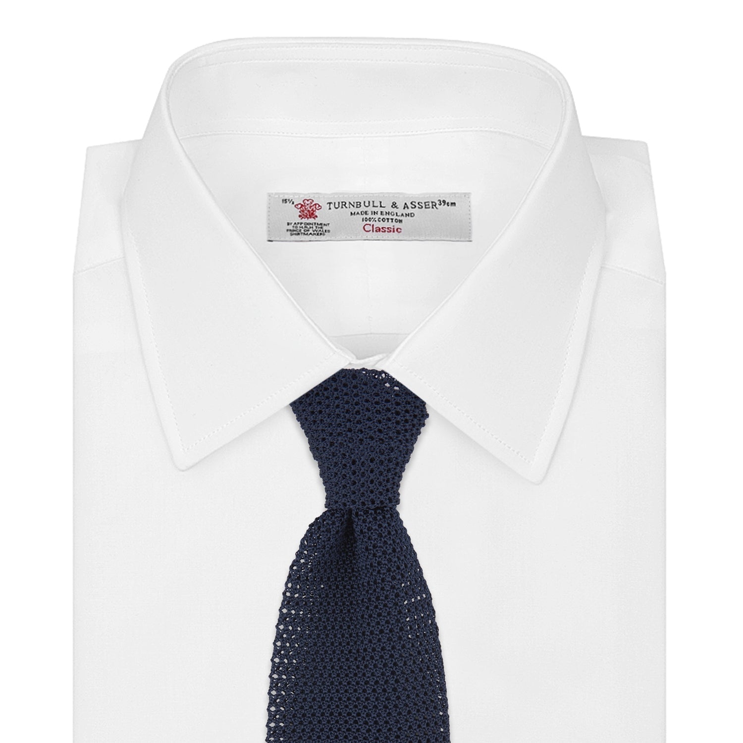 View 2 of product The Turnbull & Asser Navy Knitted Silk Tie features a textured open weave and flat squared ends, making it a versatile accessory for the modern gentleman’s wardrobe. Shown rolled up on a plain white background.