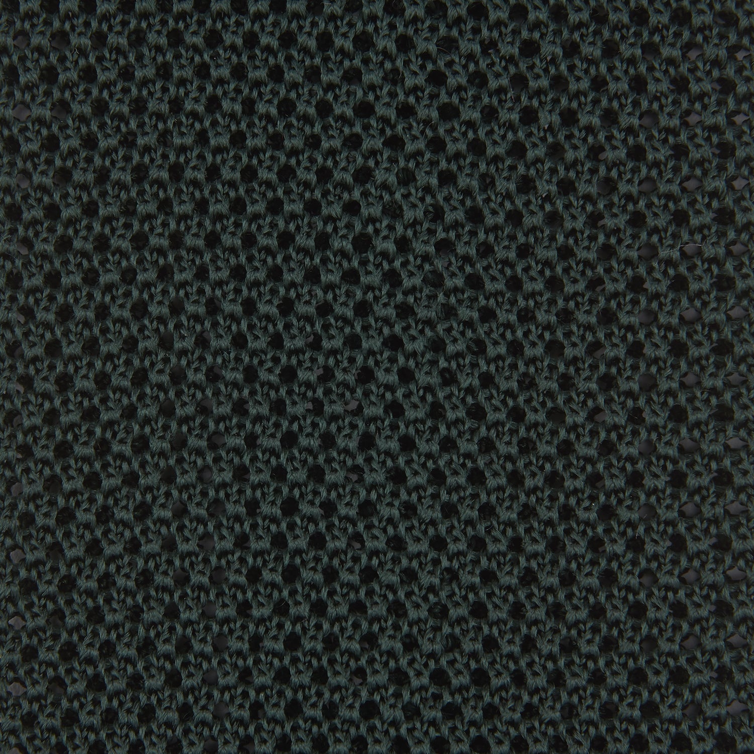 View 3 of product The Turnbull & Asser Green Knitted Silk Tie features a rich dark green hue and textured weave, making it an elegant accessory for any gentleman's wardrobe, shown rolled up against a light background.