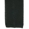 View 4 of product The Turnbull & Asser Green Knitted Silk Tie features a rich dark green hue and textured weave, making it an elegant accessory for any gentleman's wardrobe, shown rolled up against a light background.