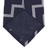 View 4 of product The Navy and White Striped Zigzag Silk Tie by Turnbull & Asser, shown rolled on a white background, features bold zigzag stripes—an ideal accessory for the modern gentleman’s everyday style.