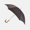 View 1 of product A practical accessory for unpredictable English weather, this Turnbull & Asser dark grey umbrella with a chestnut crook handle is shown elegantly against a plain white background.