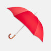 View 1 of product The Turnbull & Asser Red Umbrella with Chestnut Crook features a stylish wooden handle and sturdy metal shaft—an elegant, practical accessory ideal for facing unpredictable English weather.