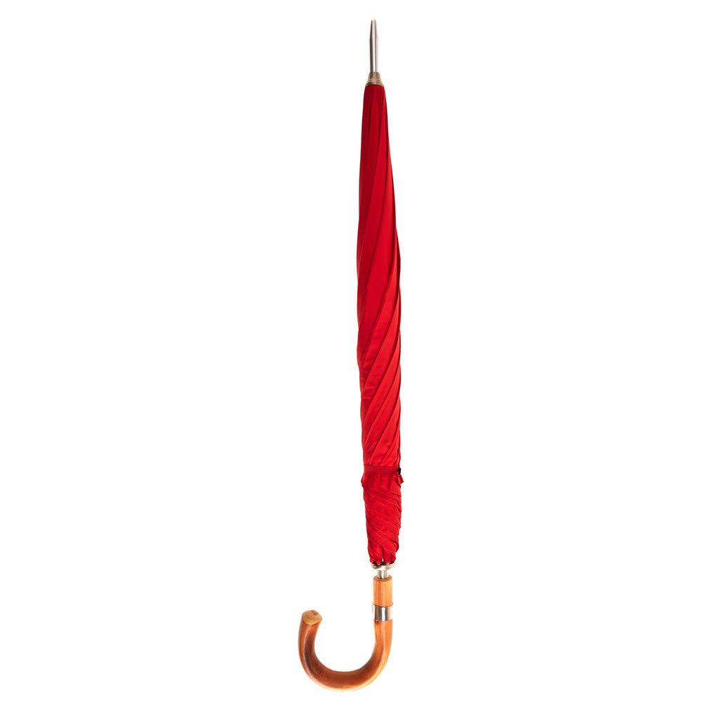 The Turnbull & Asser Red Umbrella with Chestnut Crook features a stylish wooden handle and sturdy metal shaft—an elegant, practical accessory ideal for facing unpredictable English weather.