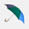View 1 of product The Turnbull & Asser Blue and Green Umbrella with Chestnut Crook features three colored panels—navy, green, bright blue—and a sturdy chestnut handle with a silver shaft, ideal for English weather. Shown on a plain white background.