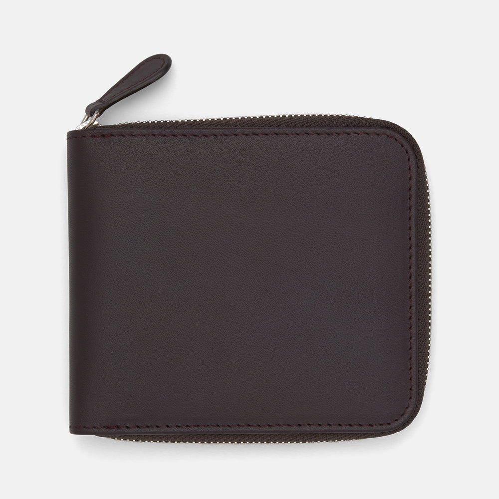 The Turnbull & Asser Violla Leather 8 C/C Zipped Wallet, in dark brown leather with a zipper along the top and side, sits on a plain light background.