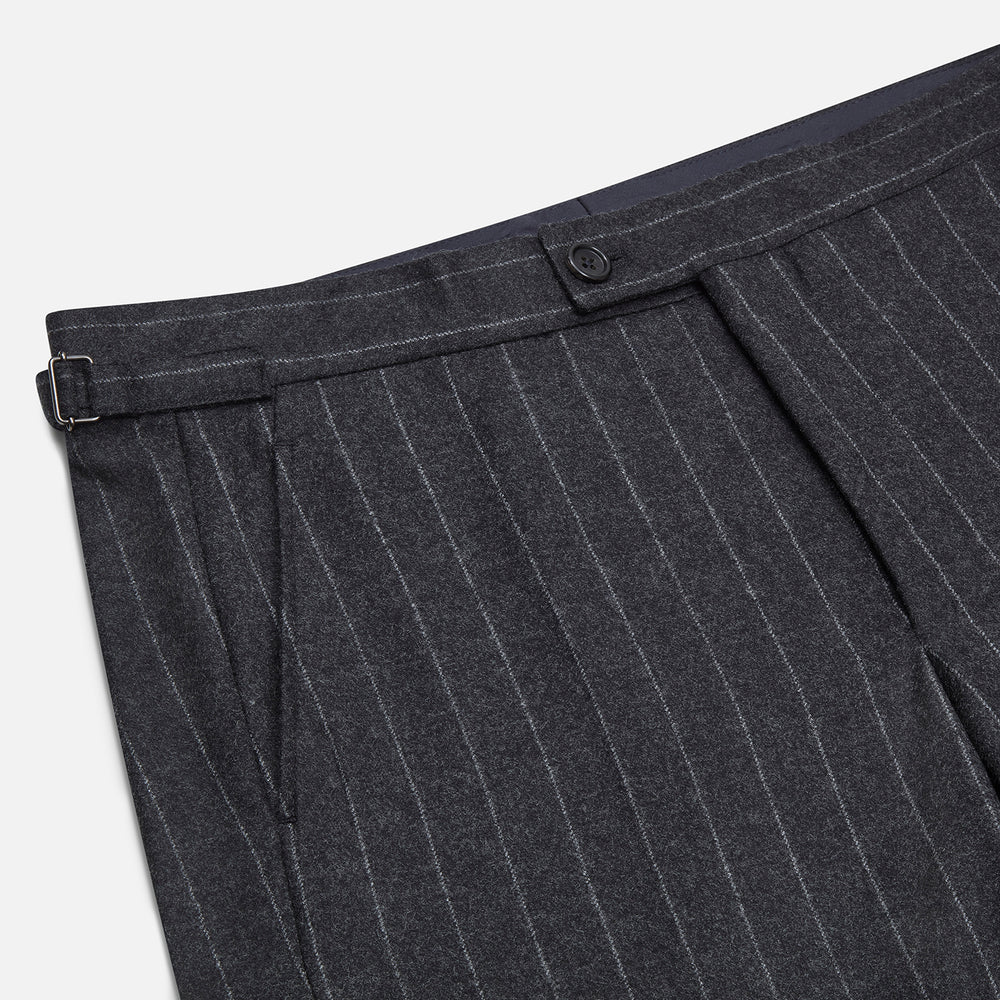 The Charcoal Pinstripe Henry Trousers by Turnbull & Asser feature white vertical stripes, a button and zip closure, belt loops, and side pockets, shown against a plain white background.