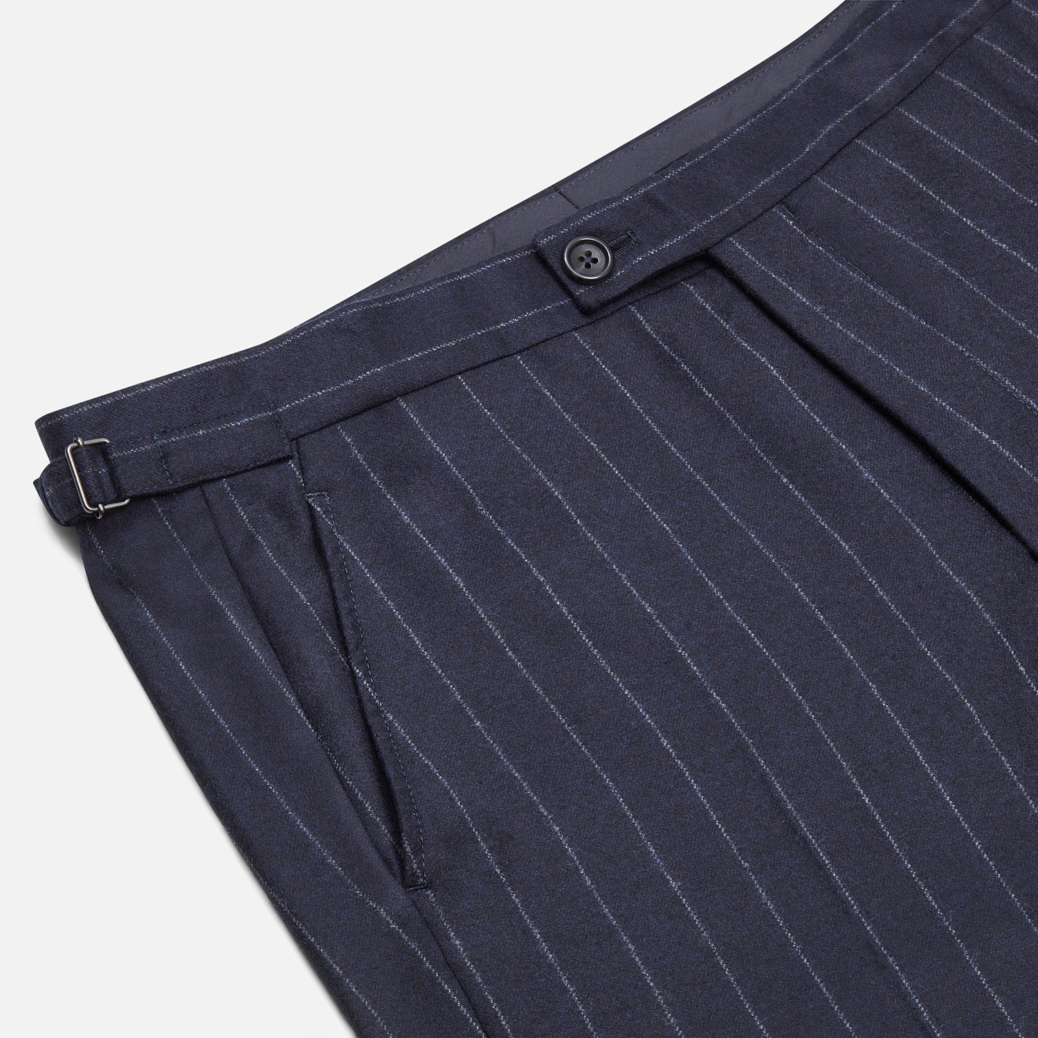 View 2 of product The Navy Pinstripe Henry Trousers by Turnbull & Asser feature vertical white stripes, a tailored fit, button closure, and belt loops. Crafted from a wool cashmere blend, they are shown against a plain white background.