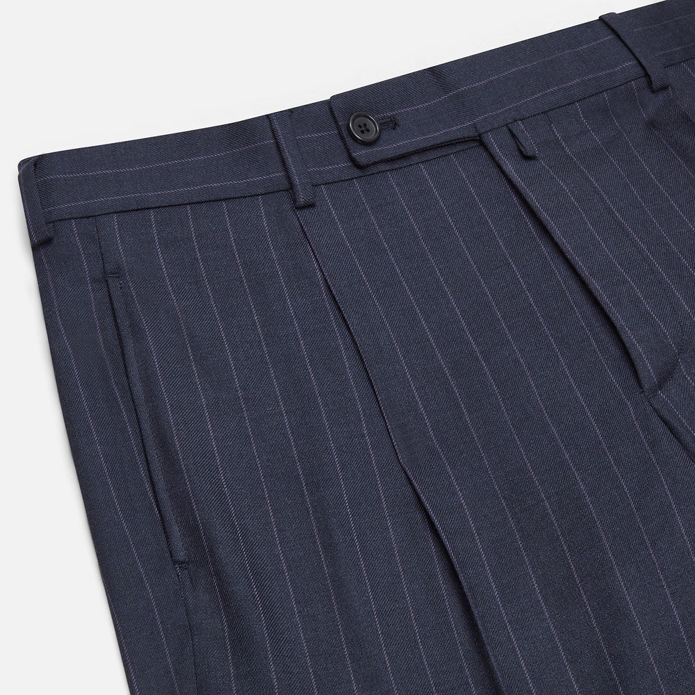 The Navy Pinstripe Arthur Trousers by Turnbull & Asser feature white vertical stripes, front pleats, a button closure, belt loops, and straight legs—adding modern menswear style to your wardrobe. Shown on a plain white background.