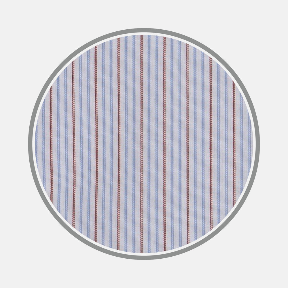 A close-up of Turnbull & Asser's Red and Navy Supraluxe Stripe Fabric, showing vertical blue, white, and red stripes within a circular frame on a plain light background.