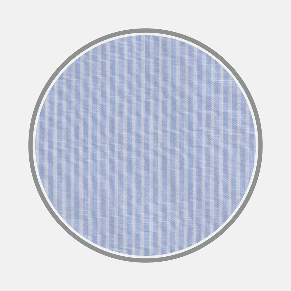 A close-up of Turnbull & Asser’s Light Blue and White Stripe Chambray Fabric shows its vertical pinstripes, captured in a gray-bordered circular frame on a white background.