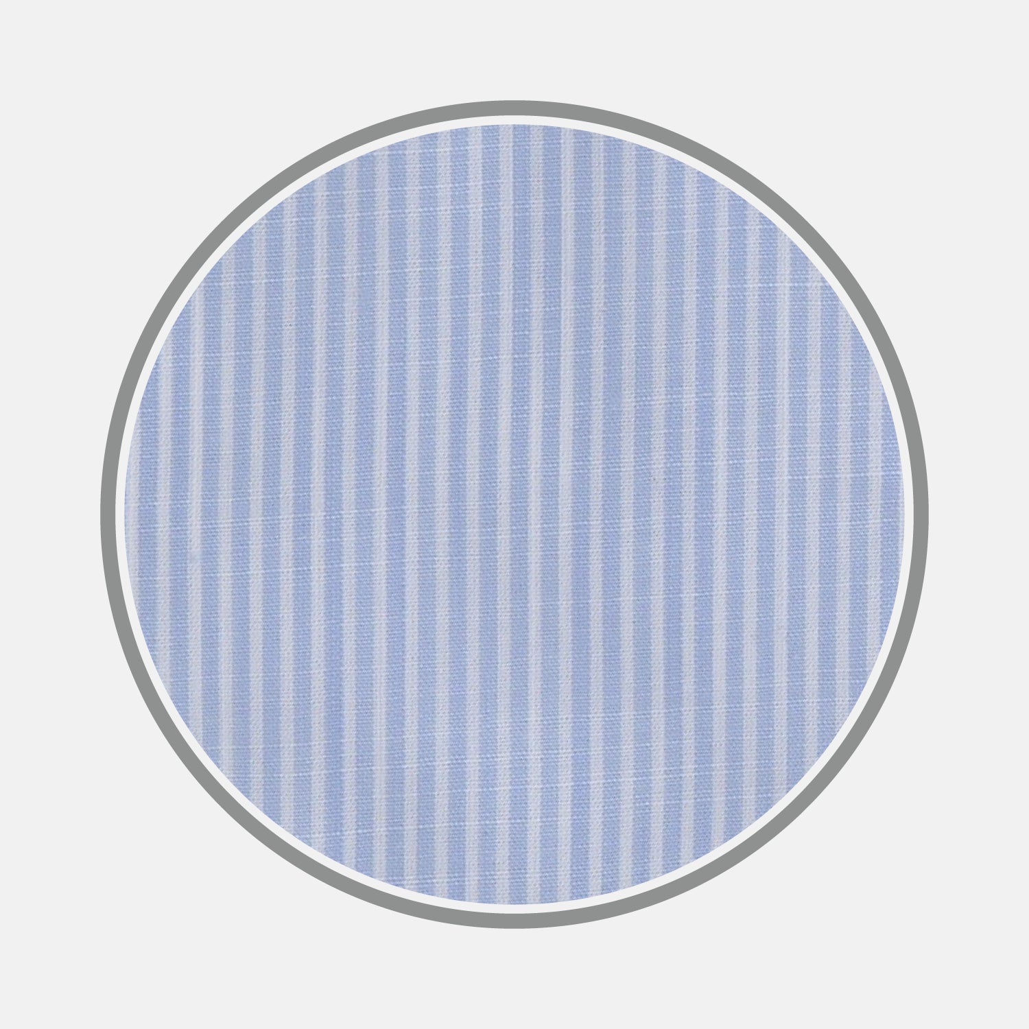 View 1 of product A close-up of Turnbull & Asser’s Light Blue and White Stripe Chambray Fabric shows its vertical pinstripes, captured in a gray-bordered circular frame on a white background.