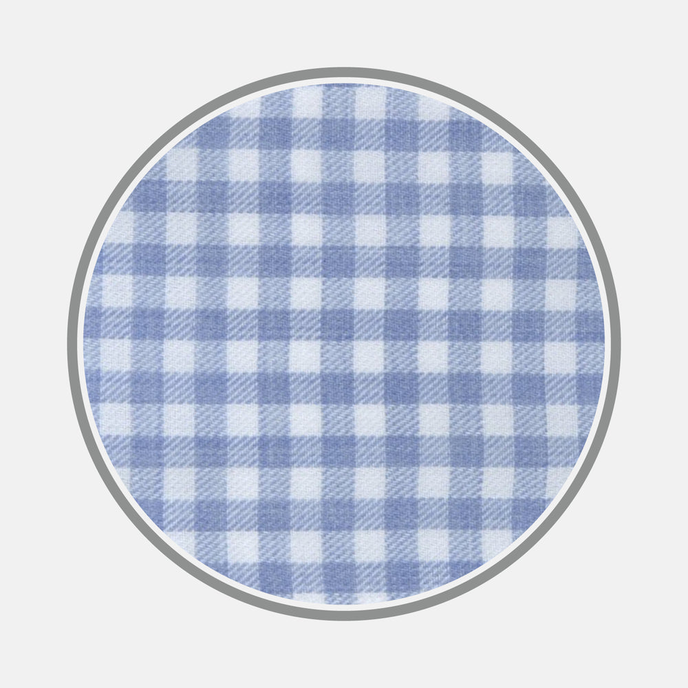 A circular swatch of Turnbull & Asser's Light Blue Gingham Cotton Fabric, featuring a blue and white checkered pattern with a thin gray border, displayed against a plain light background.