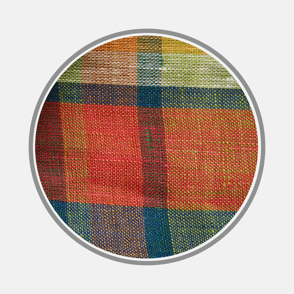 A close-up of Turnbull & Asser’s Orange Madras Check Linen Fabric, showing a vibrant plaid with intersecting red, green, yellow, blue, and orange stripes in a circular frame on a white background.