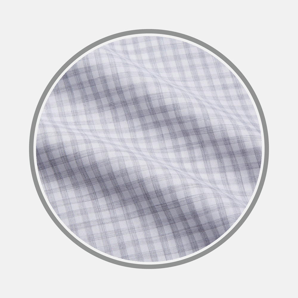Close-up of Turnbull & Asser’s Grey Check Cotton Fabric, featuring a light gray and white plaid pattern in a circular frame that highlights the smooth texture and crisp intersecting lines.