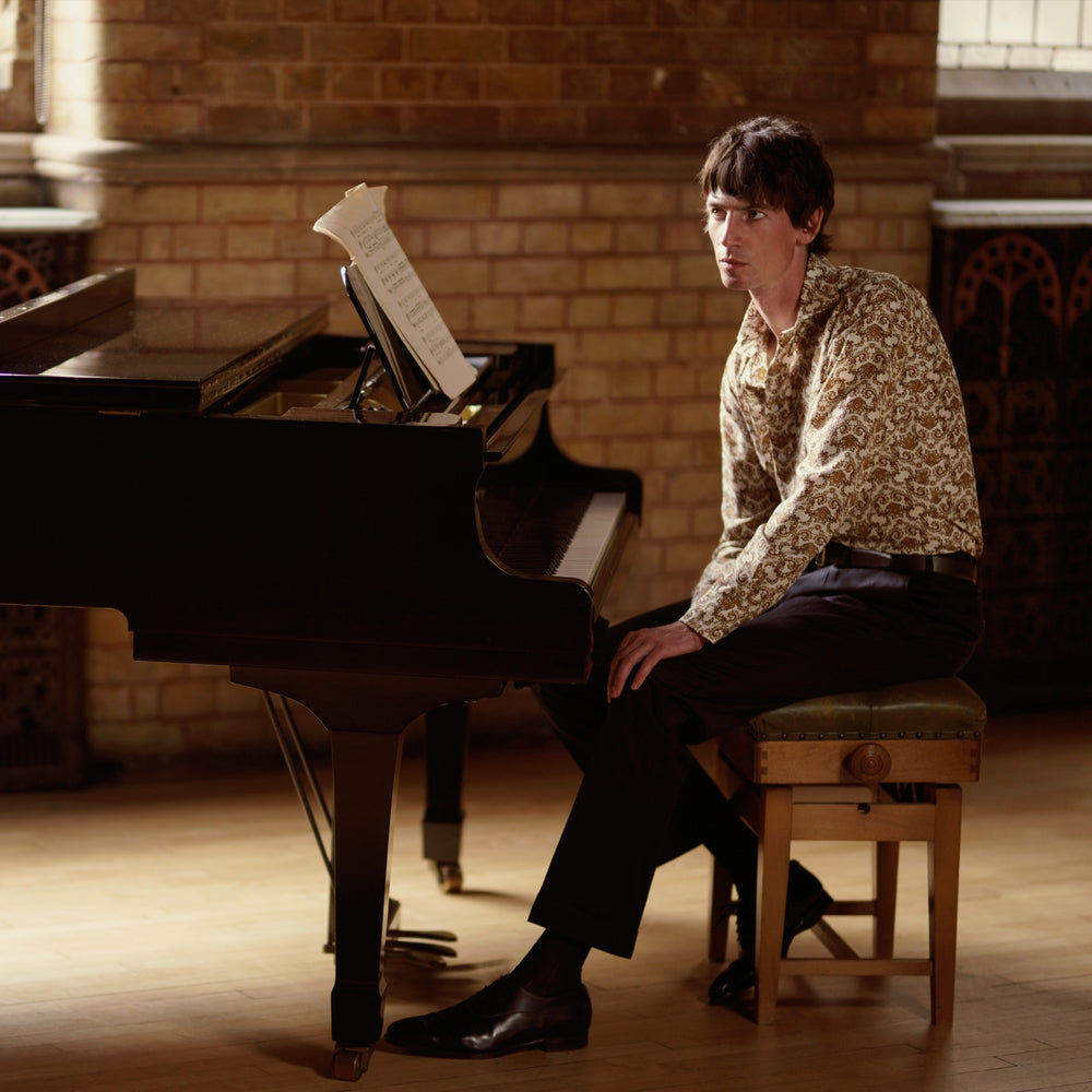 The Turnbull & Asser Tailored Fit Cream Jagger Print Silk Shirt features a Kent collar, 2-button cuffs, and an intricate brown and gold print on cream silk for timeless elegance.