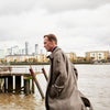View 2 of product The Turnbull & Asser Checked Wool Car Coat features a straight-cut silhouette in brown and gray Prince of Wales check, classic collar, concealed front buttons, long sleeves, and a minimalist tailored design.