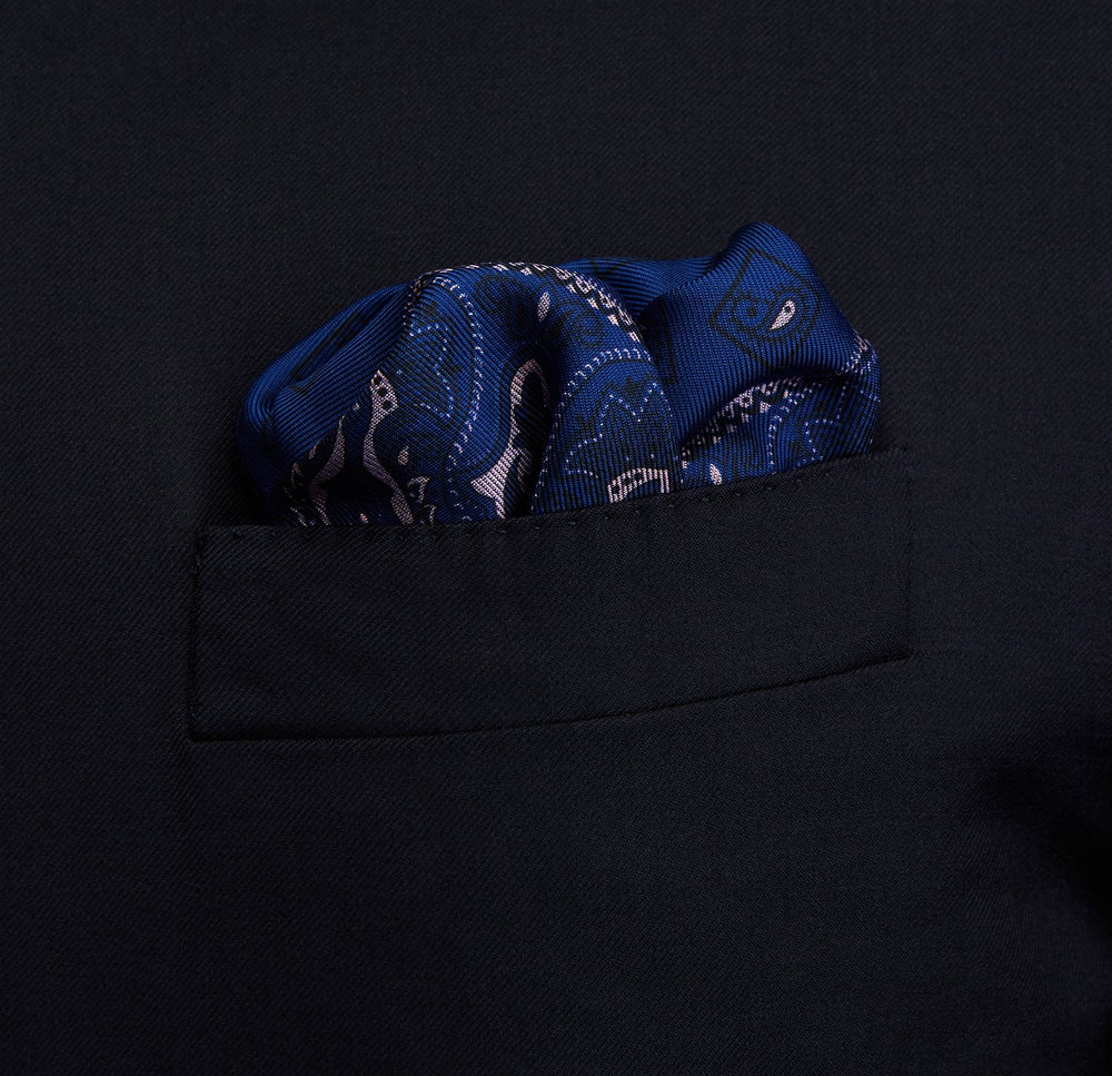 A pink and navy double-faced paisley silk bandana pocket square from Turnbull & Asser, featuring digitally printed designs with brand name in the corner.