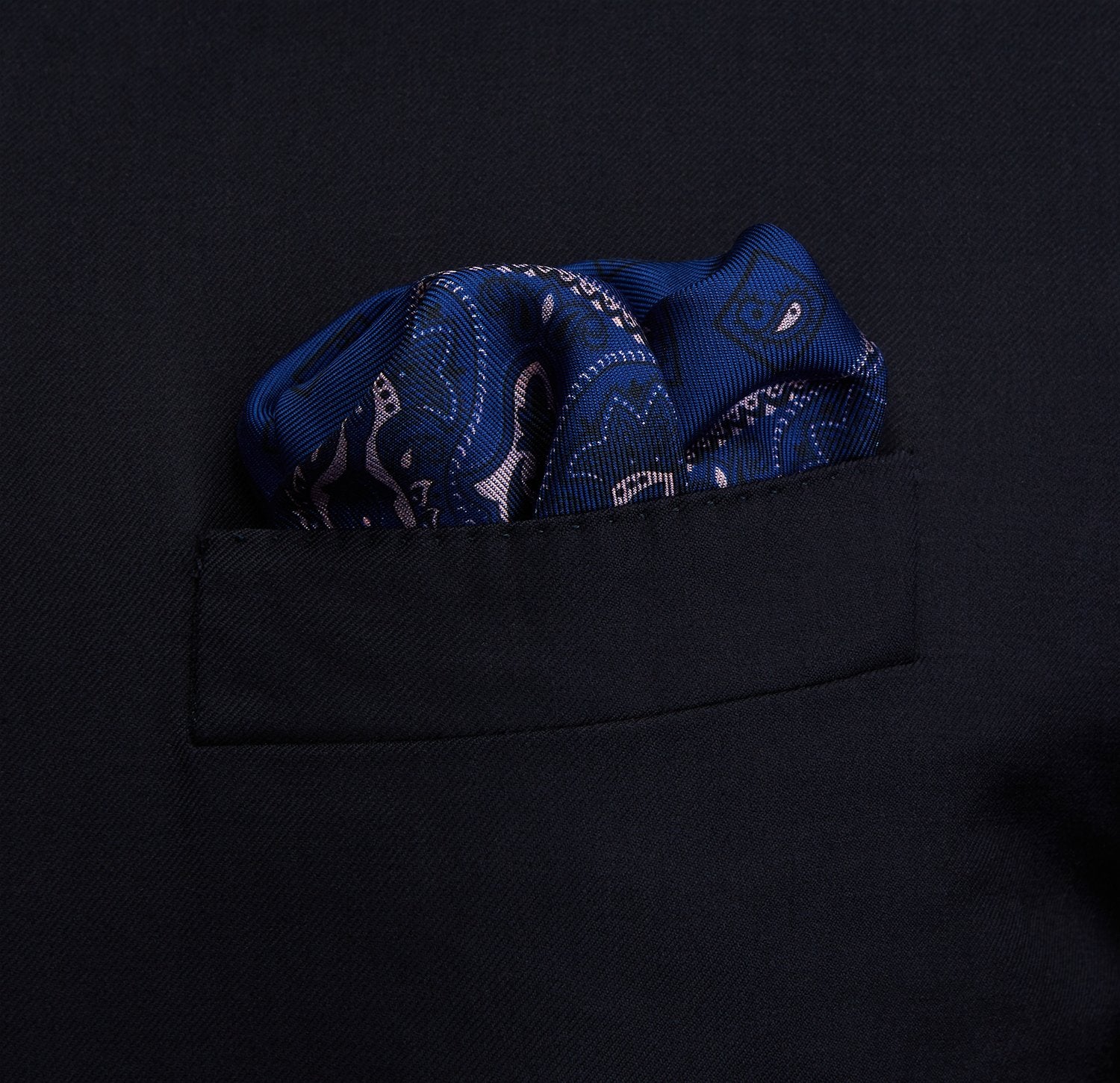 View 2 of product A pink and navy double-faced paisley silk bandana pocket square from Turnbull & Asser, featuring digitally printed designs with brand name in the corner.