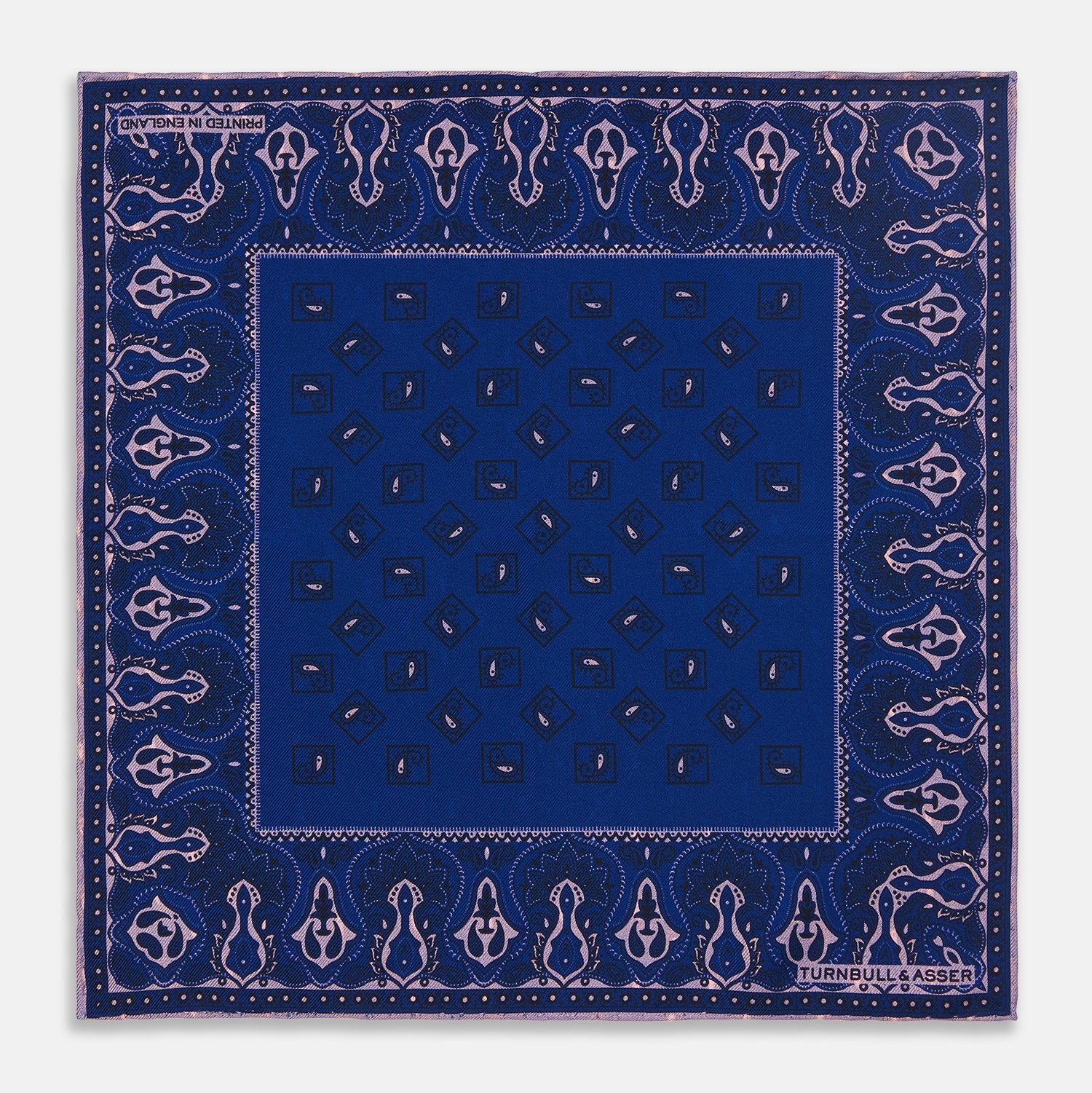 View 1 of product A pink and navy double-faced paisley silk bandana pocket square from Turnbull & Asser, featuring digitally printed designs with brand name in the corner.