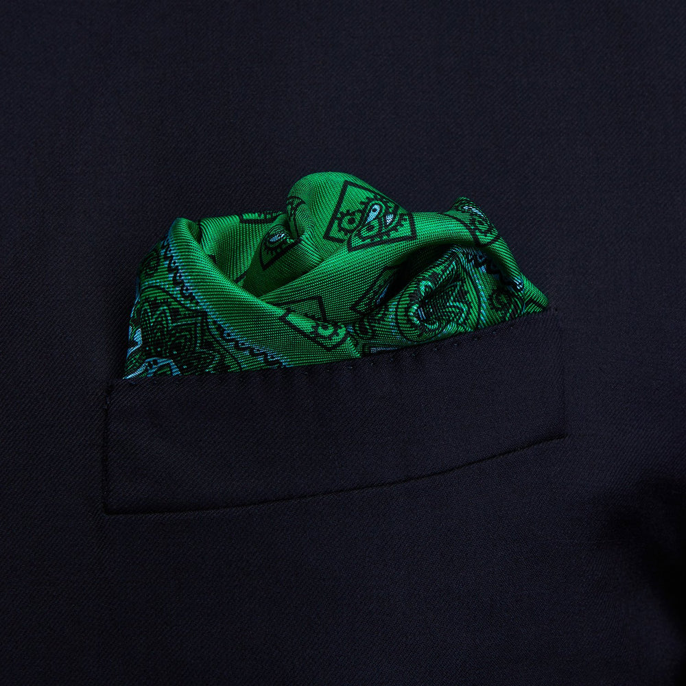 The Green & Blue Double-Faced Paisley Silk Bandana Pocket Square by Turnbull & Asser features a detailed paisley and geometric print with brand accents at the corners.