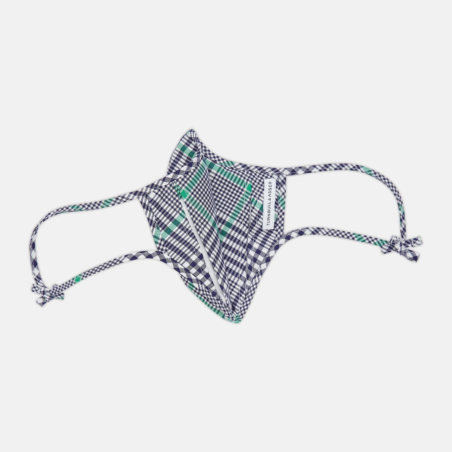 View 5 of product The Turnbull & Asser Exclusive Navy & Green Archive Check Superfine Cotton Commuter Mask features adjustable ear loops with bows and comes with 3 Viroformula™ filters.