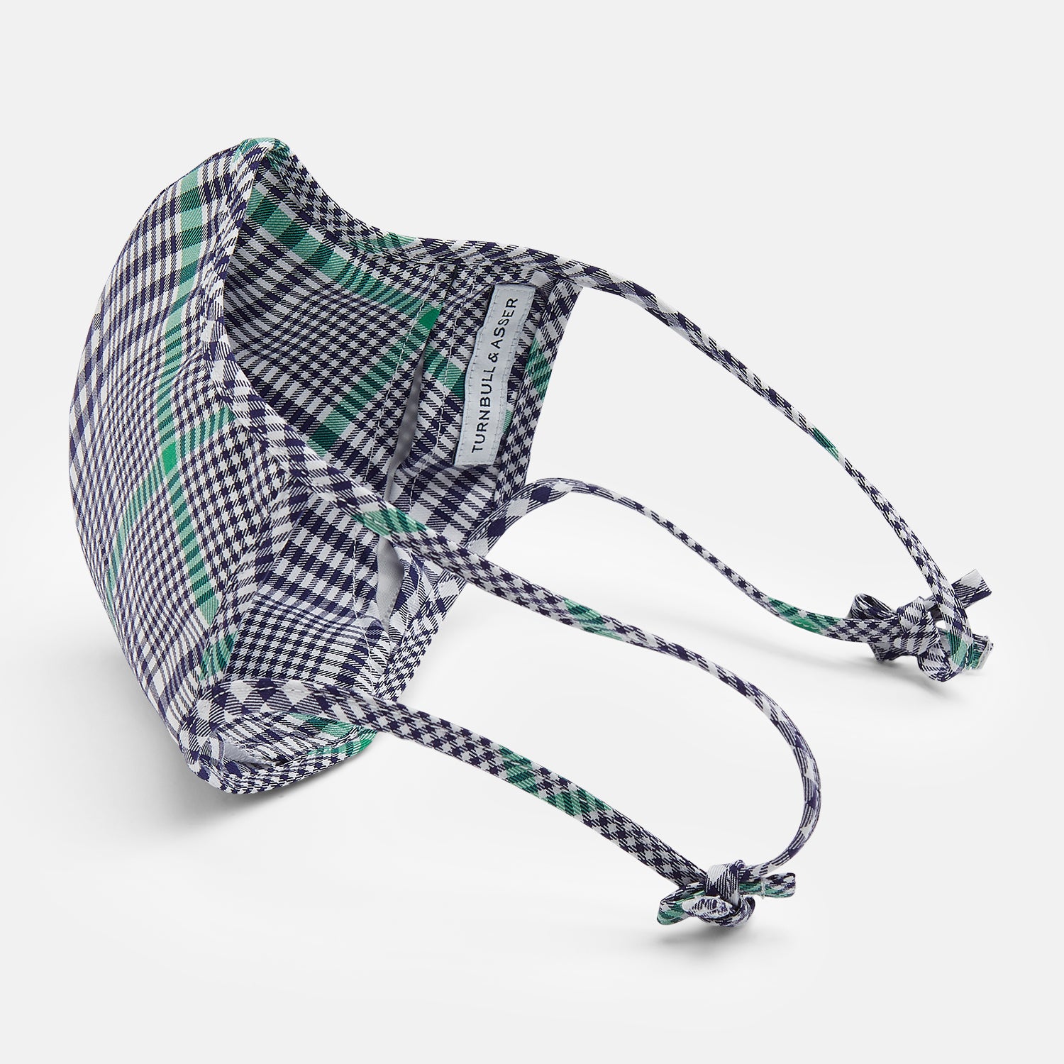 View 4 of product The Turnbull & Asser Exclusive Navy & Green Archive Check Superfine Cotton Commuter Mask features adjustable ear loops with bows and comes with 3 Viroformula™ filters.