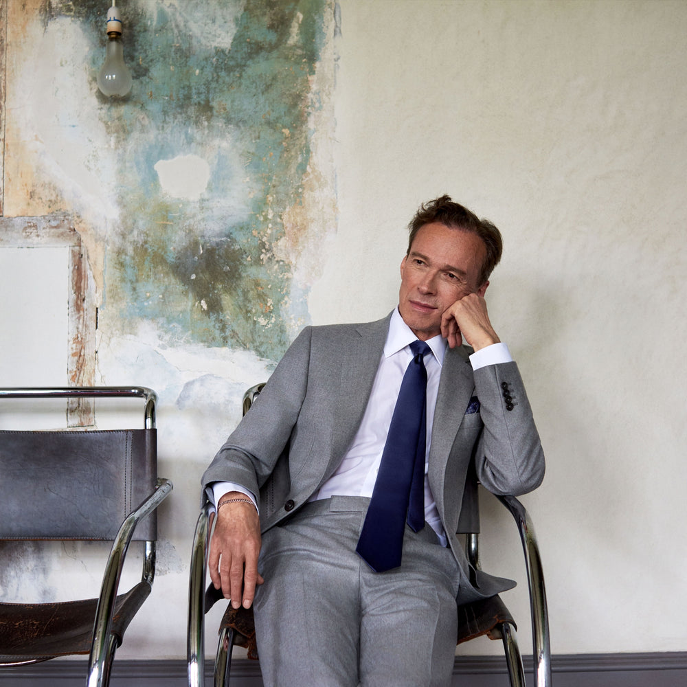 The Dove Grey Escorial Lightweight Wool Jacket by Turnbull & Asser features soft Escorial wool, a notched lapel, two front buttons, three pockets, and a single chest pocket, shown against a plain white background.