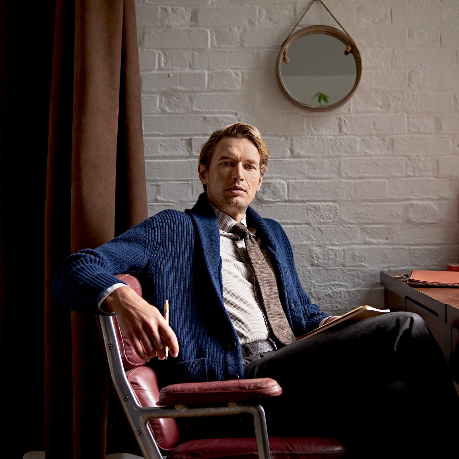 View 4 of product The Turnbull & Asser Navy Shawl Collar Cashmere Cardigan features a chunky knit, ribbed texture, button front, and two pockets—a luxurious piece laid flat on a white background for warmth and style.