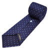 View 4 of product The Turnbull & Asser Seven-Fold Navy & Light Blue Spot Herringbone Silk Tie features a subtle herringbone weave with light blue polka dots, shown rolled up on a white background.
