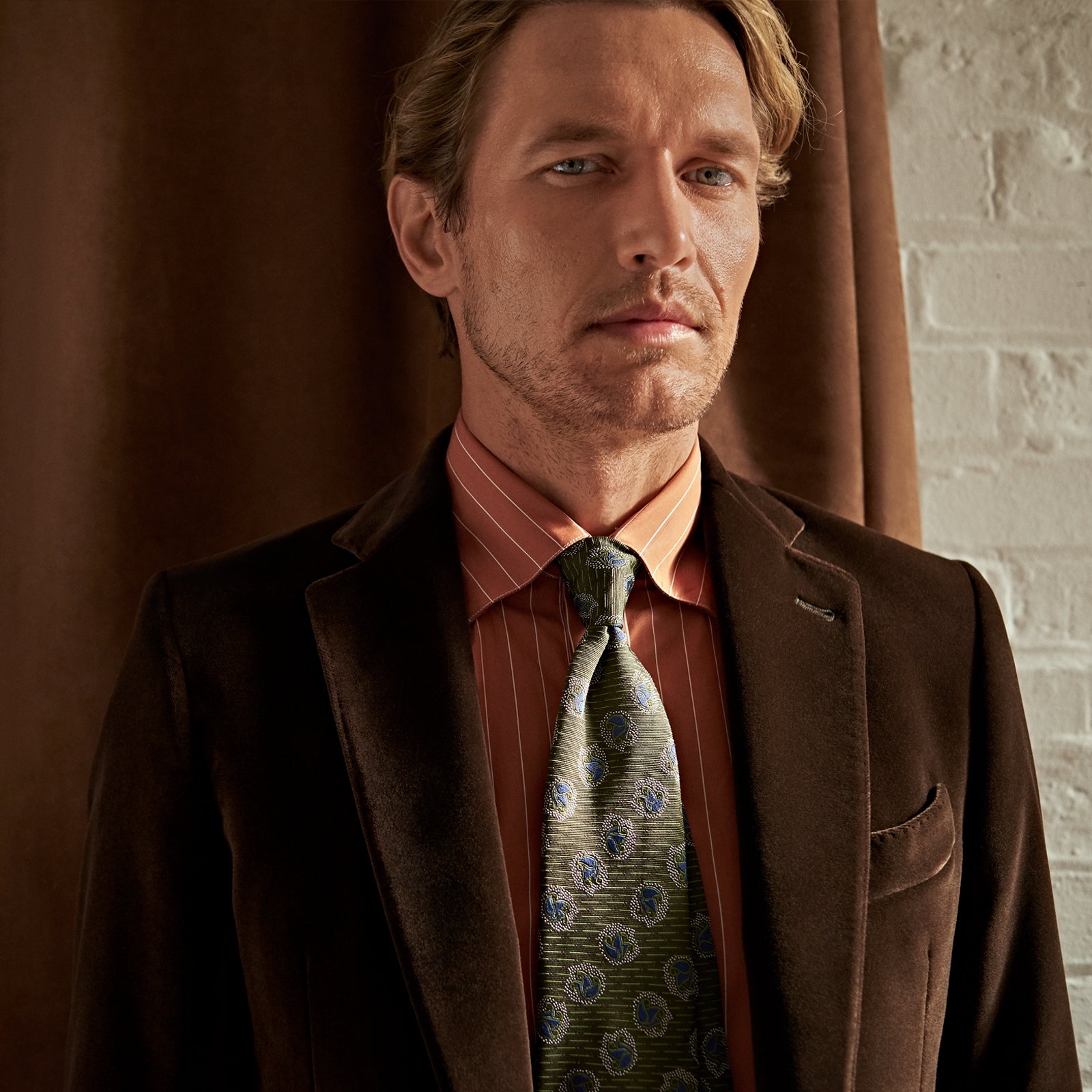 View 2 of product The Turnbull & Asser Brown Velvet Jacket for men features a notched lapel, two buttons, flap pockets, and a chest pocket, shown against a plain white background.