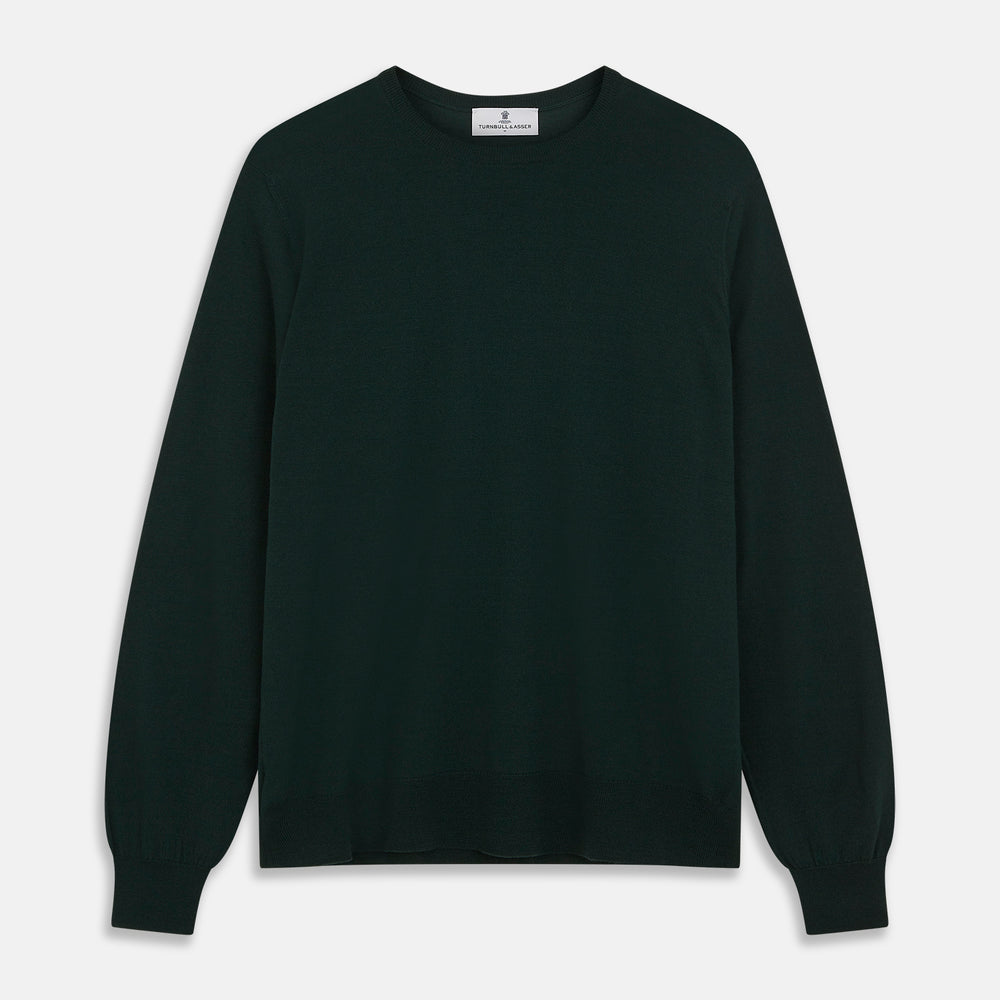 The Turnbull & Asser Forest Green Crew Neck Merino Jumper features ribbed cuffs and hem for a classic look. Laid flat on a white background, this luxury long-sleeve sweater is an essential, timeless addition to any wardrobe.