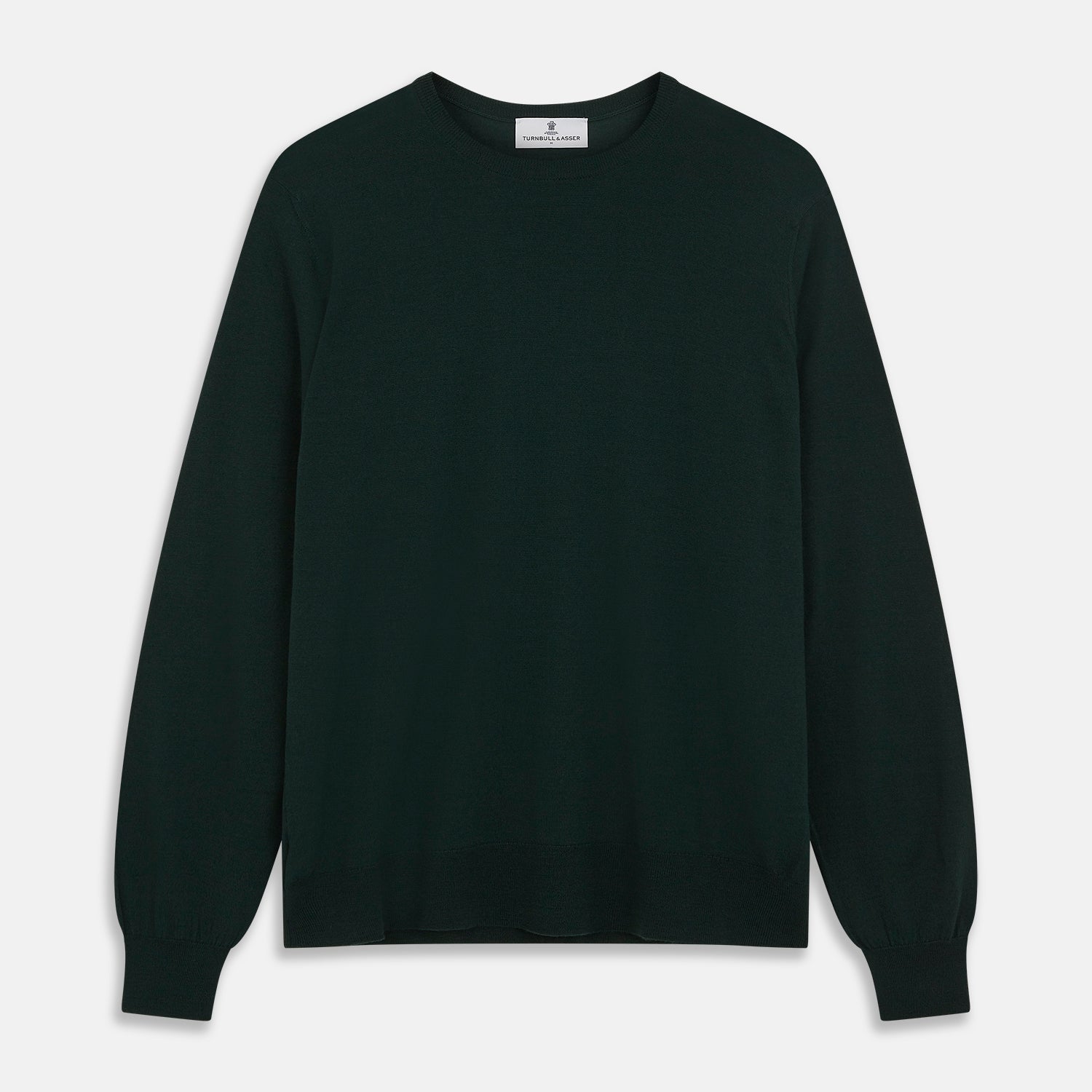 View 1 of product The Turnbull & Asser Forest Green Crew Neck Merino Jumper features ribbed cuffs and hem for a classic look. Laid flat on a white background, this luxury long-sleeve sweater is an essential, timeless addition to any wardrobe.