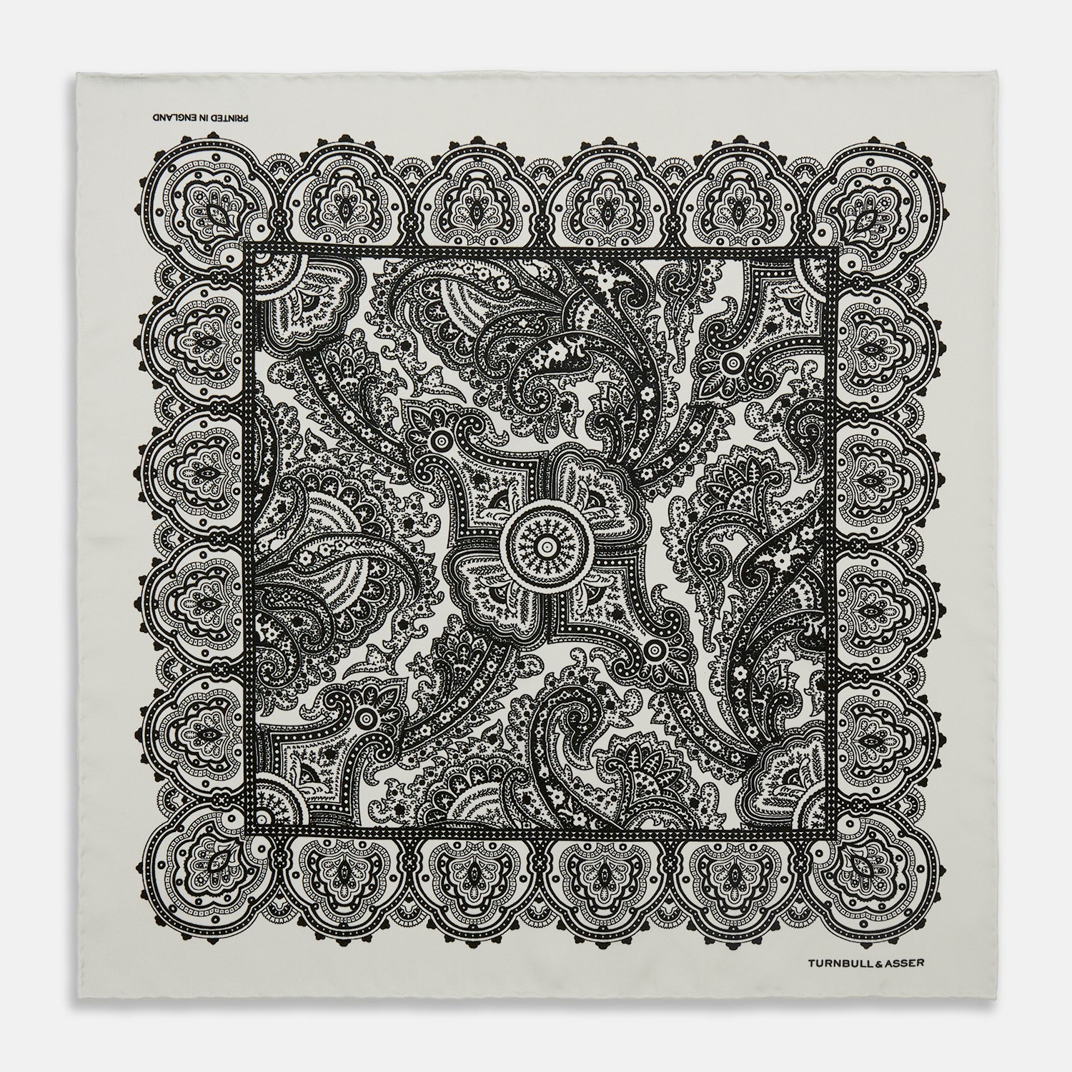 View 1 of product The White Persian Paisley Pocket Square by Turnbull & Asser features a refined black paisley and floral pattern with a decorative border, making it a sophisticated, festive gift.