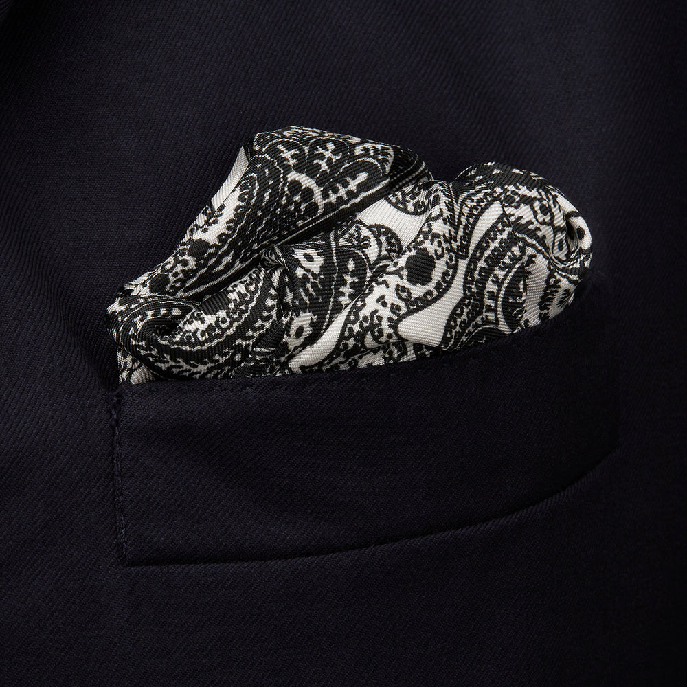The White Persian Paisley Pocket Square by Turnbull & Asser features a refined black paisley and floral pattern with a decorative border, making it a sophisticated, festive gift.