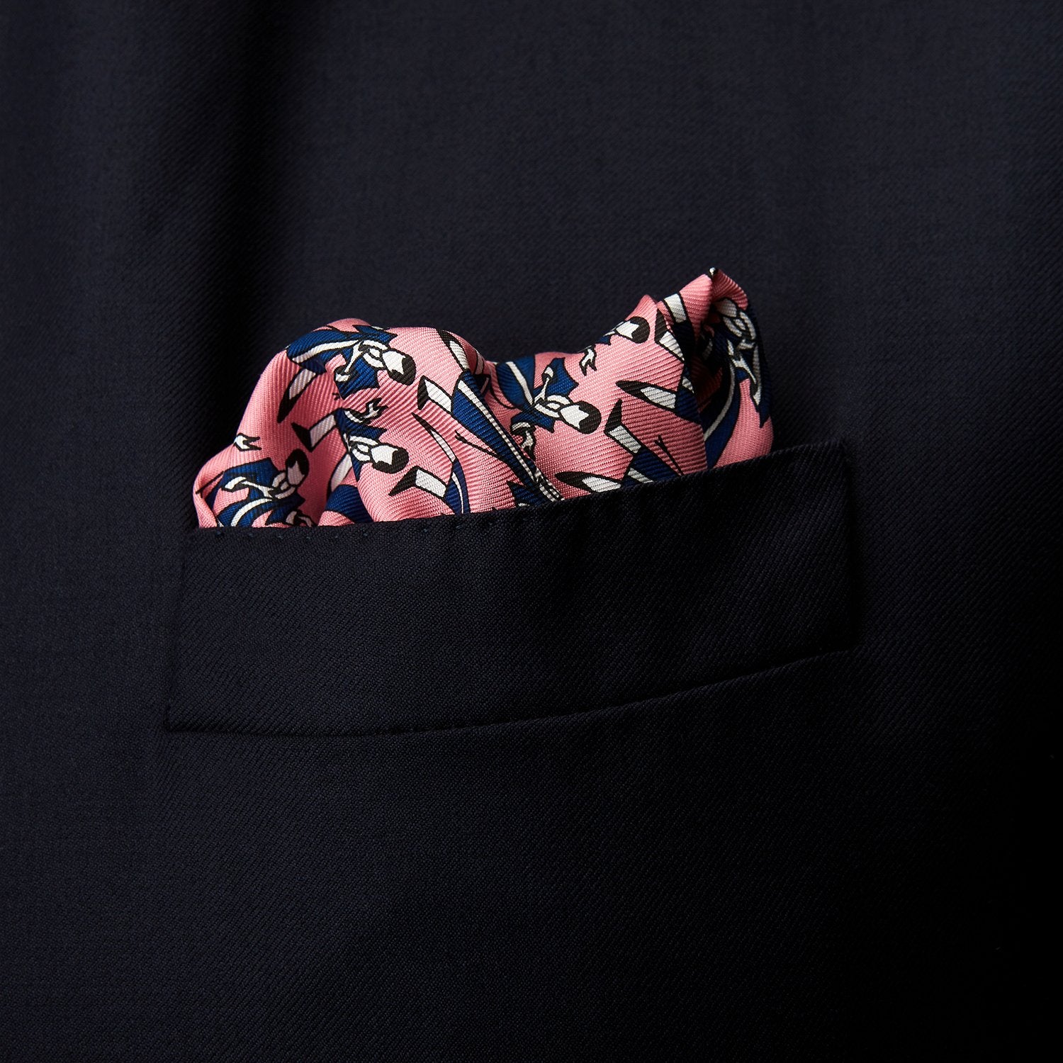 View 2 of product The Pink Dressing Gowns Pocket Square by Turnbull & Asser features a pink base inspired by classic dressing gowns, with black and white illustrated golfers in swinging poses and navy and pink striped borders.