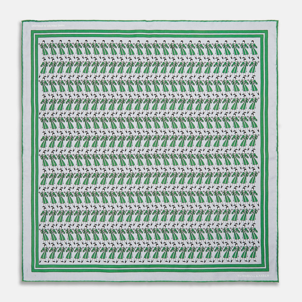 The Turnbull & Asser Green Dressing Gowns Pocket Square features a white silk base with green lines and a repeating pattern of green and black illustrated golfers, inspired by classic Turnbull dressing gown designs.