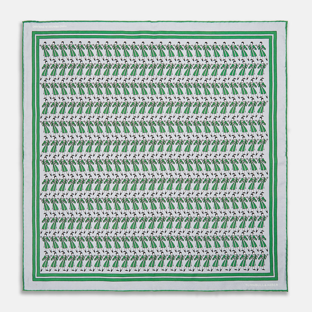 The Turnbull & Asser Green Dressing Gowns Pocket Square features a white silk base with green lines and a repeating pattern of green and black illustrated golfers, inspired by classic Turnbull dressing gown designs.