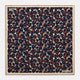 The Blue Berry Floral Pocket Square by Turnbull & Asser features a navy blue silk background with red berry and white leaf designs, plus small labels on two corners—making it a perfect festive gift.