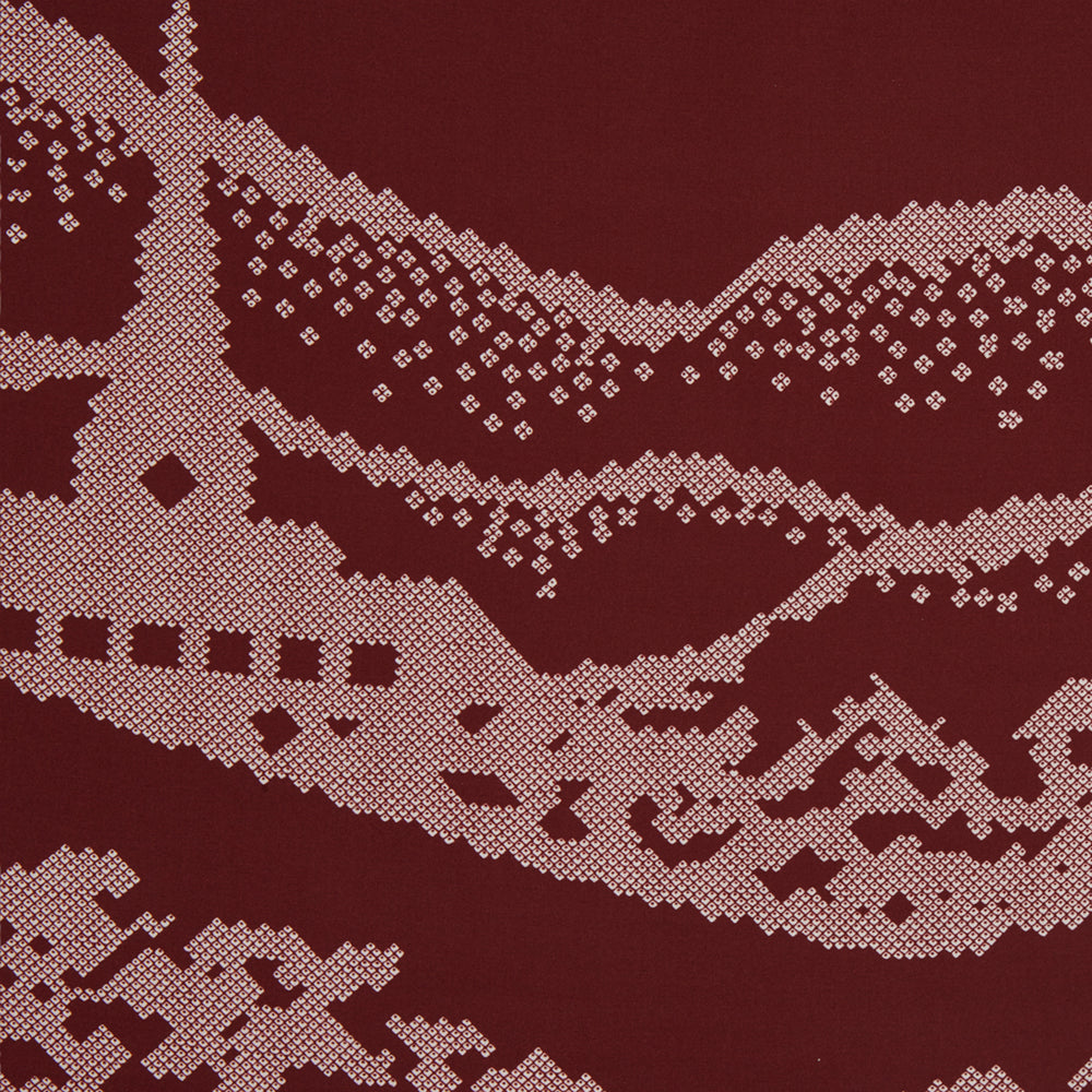 The Burgundy Snowscape Motif Silk Extra Large Scarf by Turnbull & Asser features a hand-rolled edge and a pink cross-stitch village scene—houses, church, hills—printed in England. A refined winter accessory.