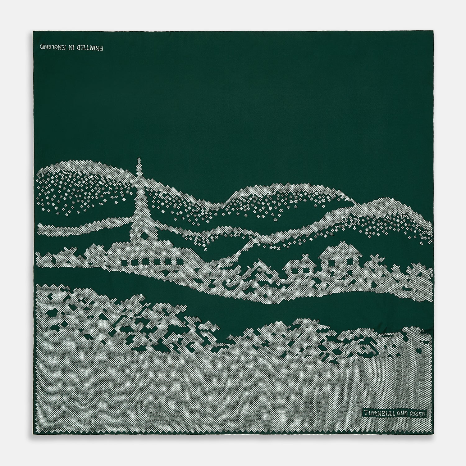 View 1 of product The Green Snowscape Motif Silk Extra Large Scarf by Turnbull & Asser features a white embroidered winter landscape with hills, trees, a church, and houses. "TURNBULL AND ASSER" appears in the corner. Made in England—perfect for winter.