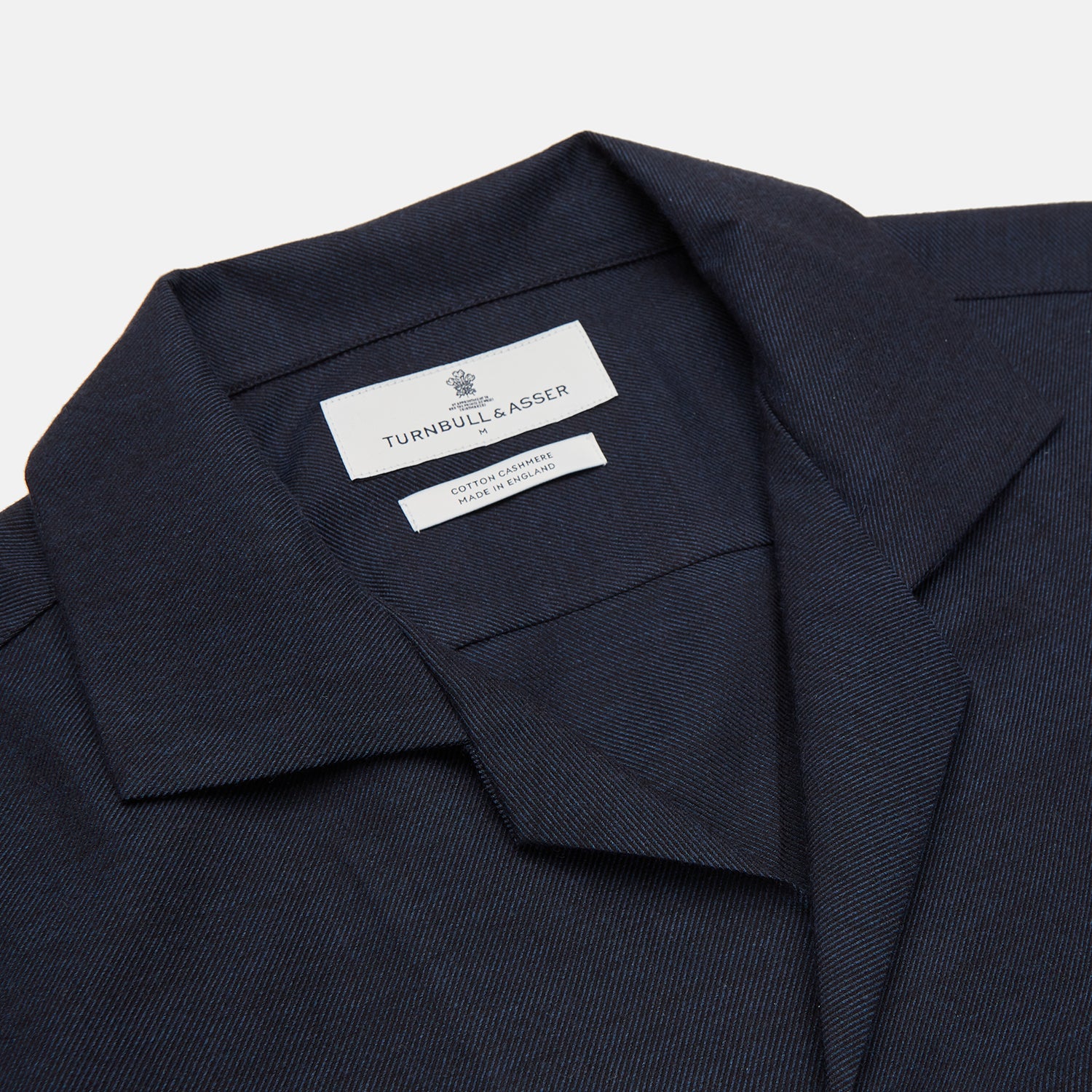 View 2 of product The Turnbull & Asser Holiday Fit Navy Cotton and Cashmere Blend Shirt features 1-button cuffs, a notched collar, and a single chest pocket, shown against a plain white background.