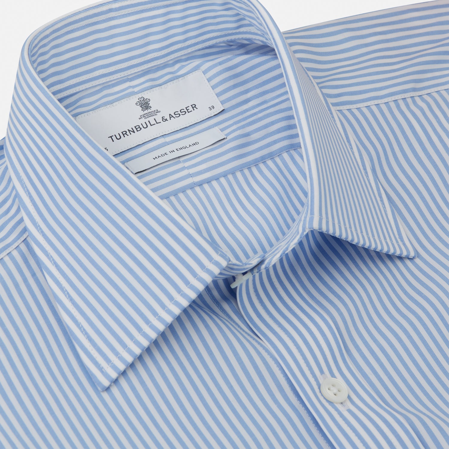 View 2 of product The Turnbull & Asser Light Blue Bengal Stripe Shirt features white vertical stripes, a classic T&A collar, and 3-button cuffs. Buttoned down the front, it’s laid flat on a white background for a timeless British look.