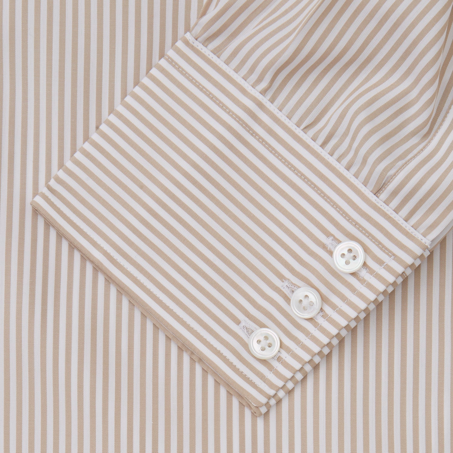 View 3 of product The Turnbull & Asser Sand Bengal Stripe Regular Fit Shirt features thin sand stripes, a T&A collar, and 3-button cuffs. Shown laid flat on a white background.