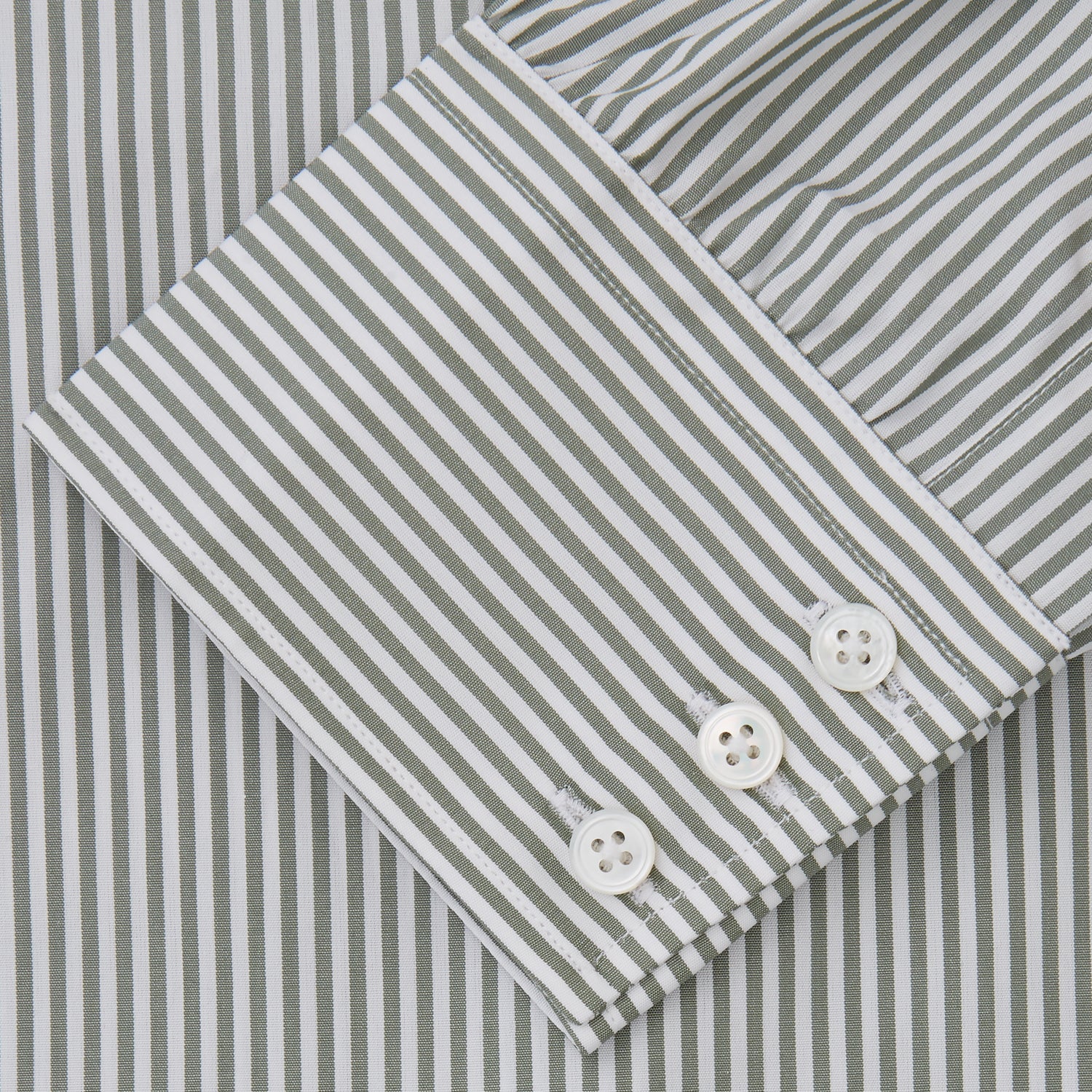 View 3 of product The Turnbull & Asser Green Bengal Stripe Regular Fit Shirt features thin green stripes, a T&A collar, and 3-button cuffs, shown on a plain white background.