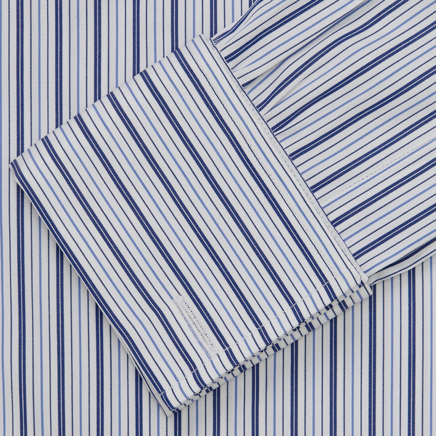 View 5 of product The Turnbull & Asser Navy Stripe Regular Fit Shirt features a T&A collar, square double cuffs, and thin vertical navy stripes on white.