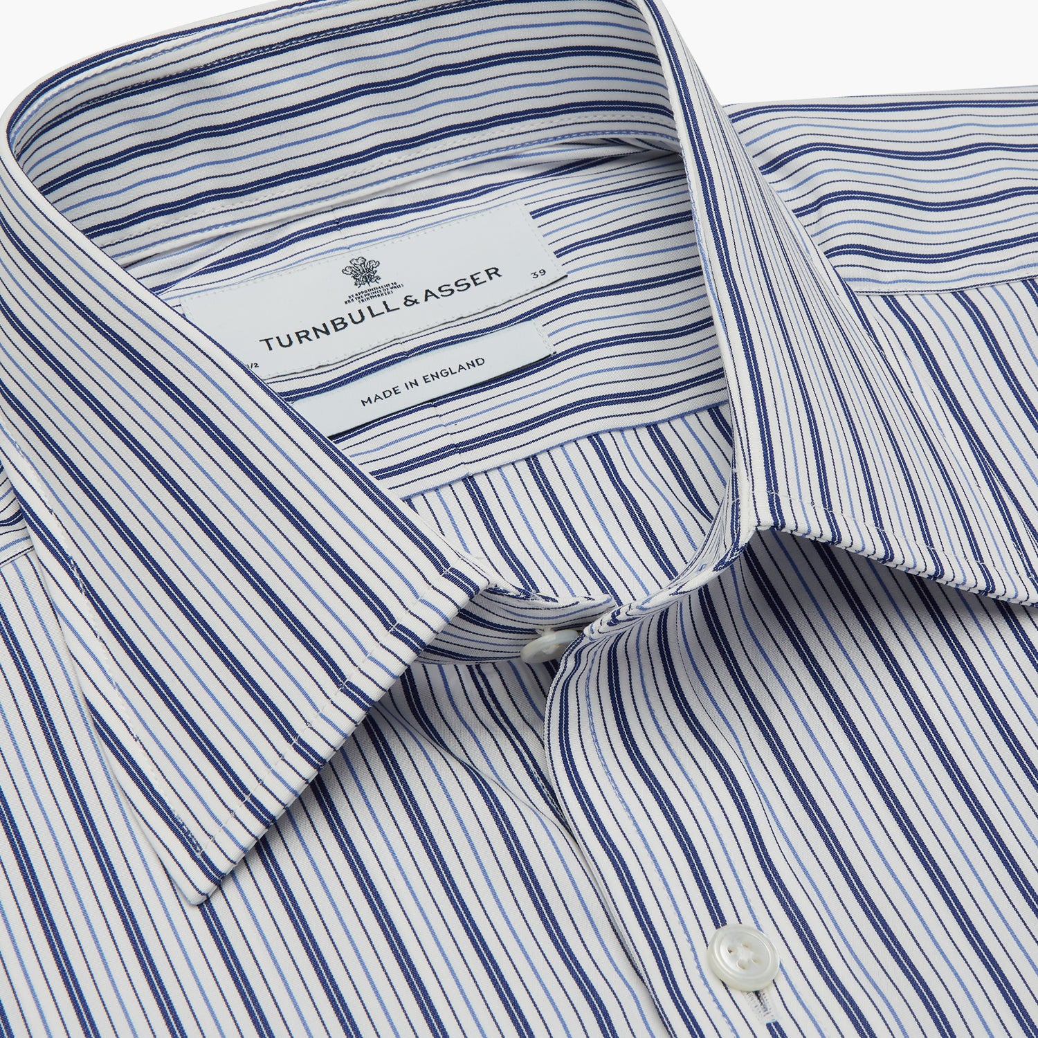 View 4 of product The Turnbull & Asser Navy Stripe Regular Fit Shirt features a T&A collar, square double cuffs, and thin vertical navy stripes on white.