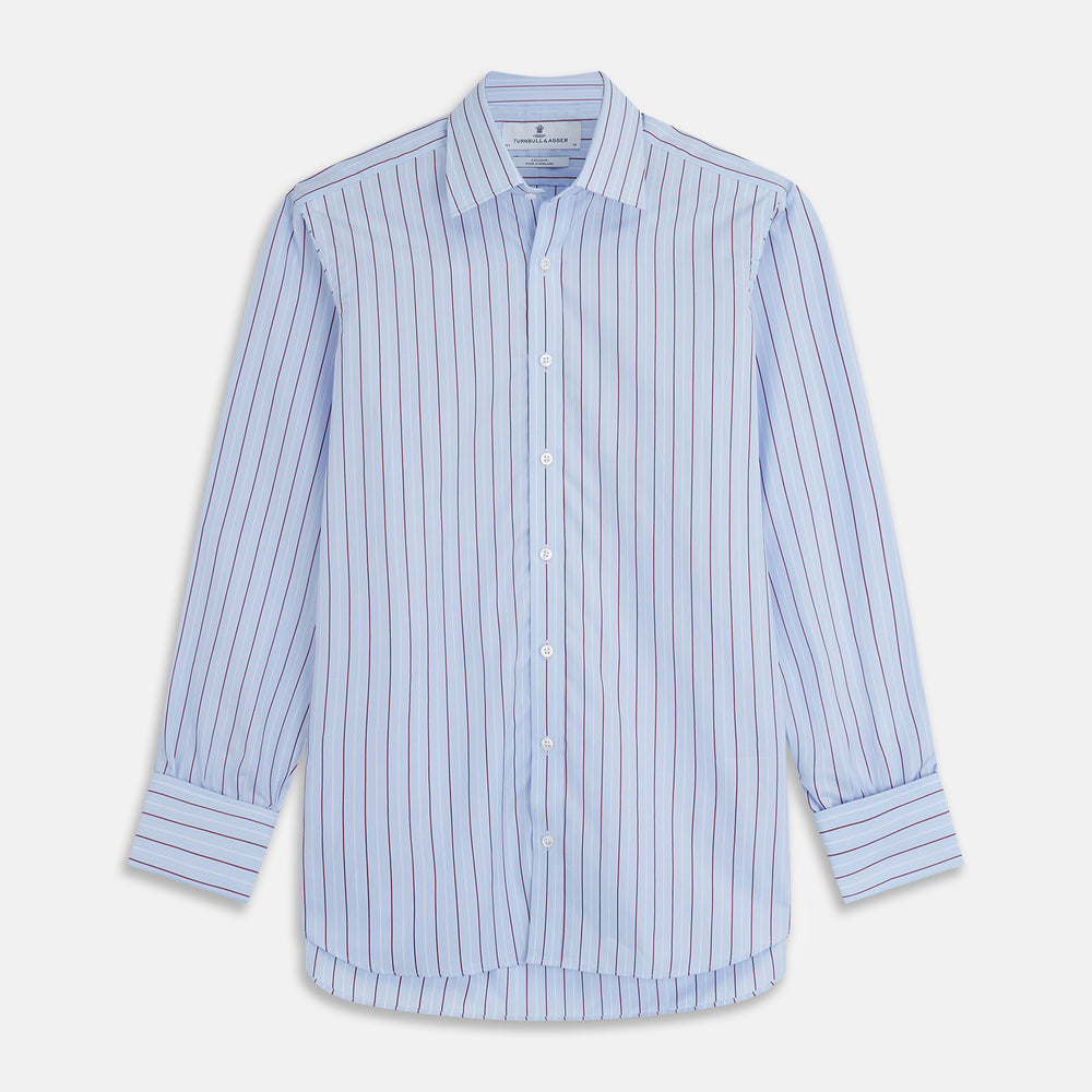 The Turnbull & Asser Burgundy Stripe Regular Fit Shirt features a T&A collar, double cuffs, and white buttons. Made from light blue Italian cotton poplin with vertical burgundy and white pinstripes. Laid flat on a white background.