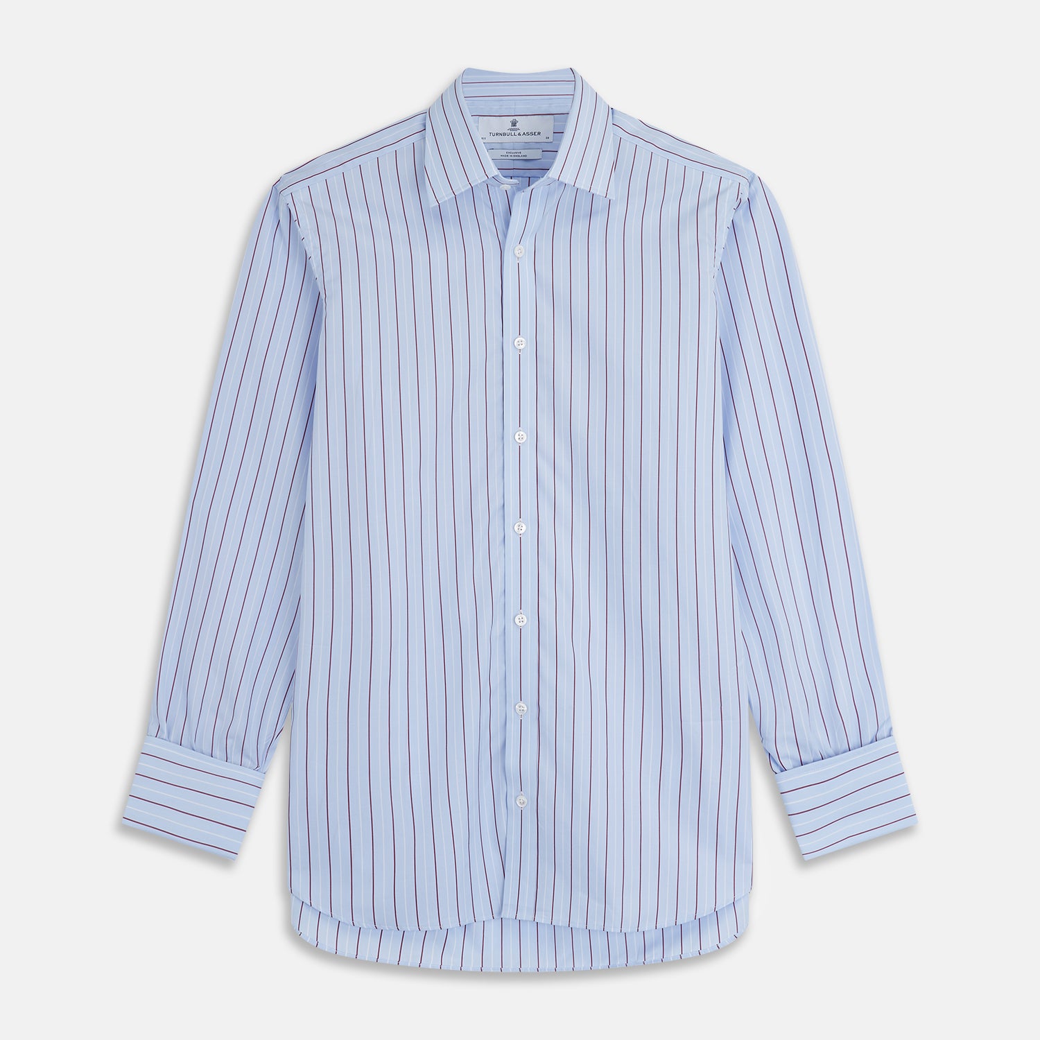 View 1 of product The Turnbull & Asser Burgundy Stripe Regular Fit Shirt features a T&A collar, double cuffs, and white buttons. Made from light blue Italian cotton poplin with vertical burgundy and white pinstripes. Laid flat on a white background.