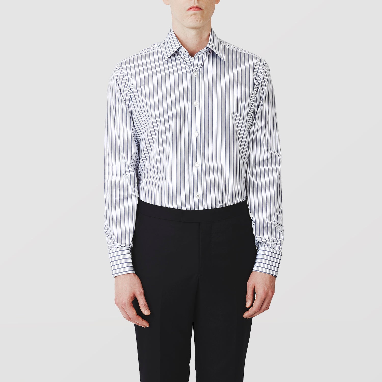 View 2 of product The Turnbull & Asser Navy Stripe Regular Fit Shirt features a T&A collar, square double cuffs, and thin vertical navy stripes on white.