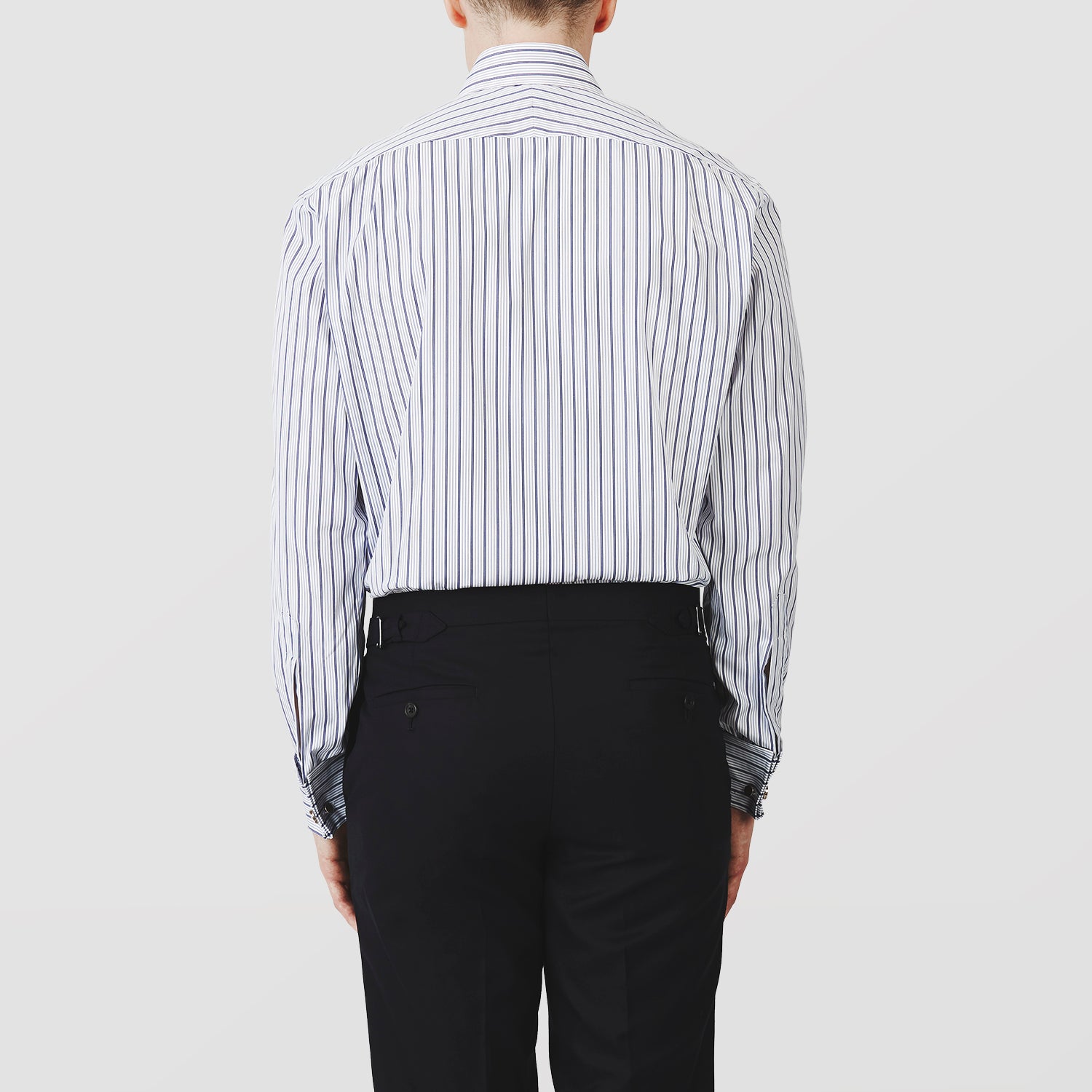 View 3 of product The Turnbull & Asser Navy Stripe Regular Fit Shirt features a T&A collar, square double cuffs, and thin vertical navy stripes on white.